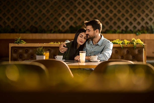 istock Tranquil couple relaxing together in cafe. 2208024404