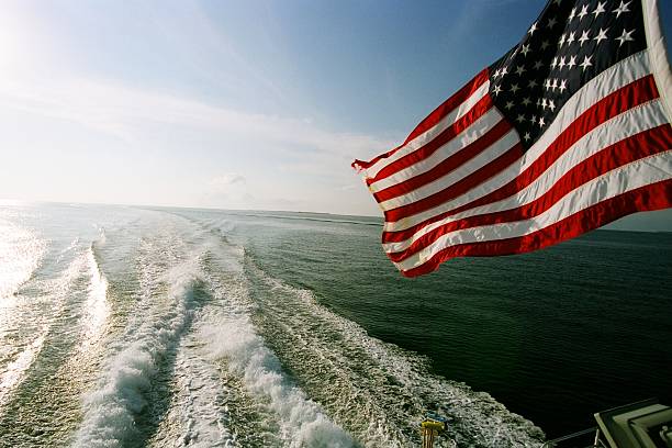 istock AMERICAN FLAG OVER THE OCEAN 2208024959