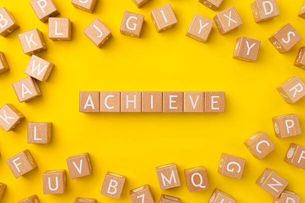 istock Block Words with Achieve on a Yellow Background 2208025561