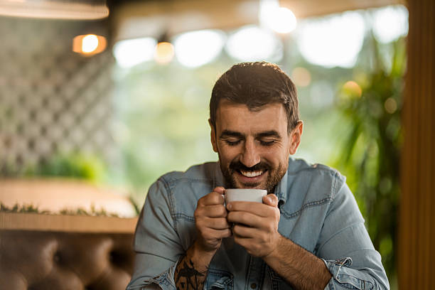 istock Young man relaxing on coffee break in cafe. 2208025815