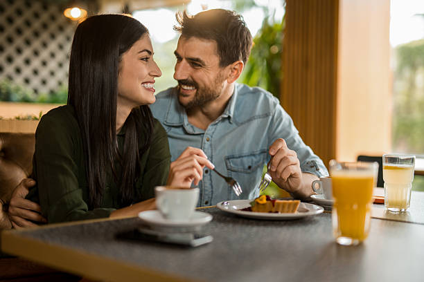 istock Happy couple eating dessert in cafe. 2208026009