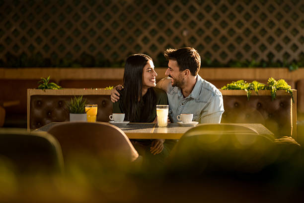 istock Happy couple flirting in cafe. 2208026177