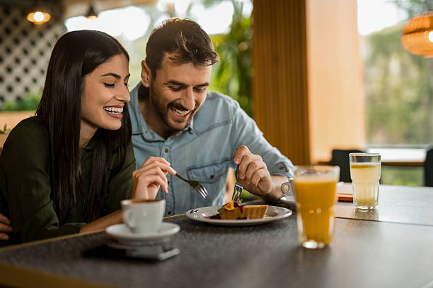 istock Cute couple eating dessert in a restaurant. 2208026353