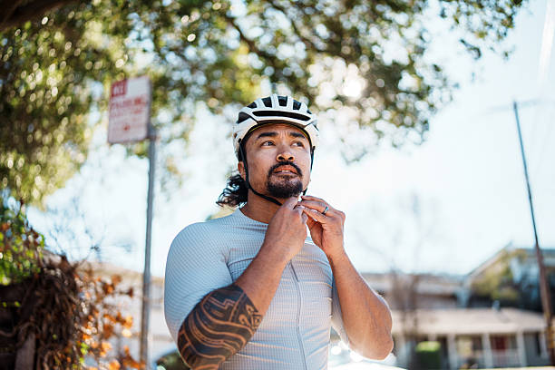 istock Man putting on bike helmet before heading out for a ride 2208026389