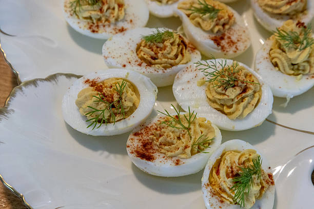 istock Deviled eggs with hummus in a porcelain dish rimmed with gold 2208027839
