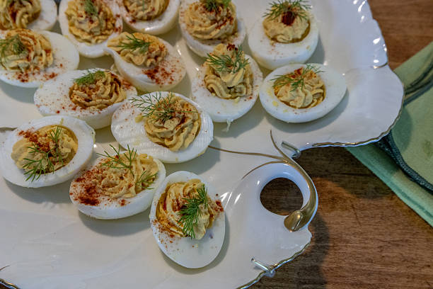 istock Deviled eggs with hummus in a porcelain dish rimmed with gold 2208027845