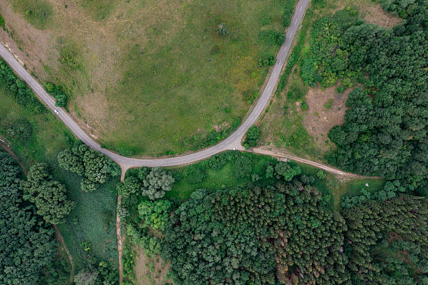 istock Harvested farmland bordered by forest from above 2208028190