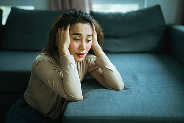 istock Lonely Asian woman having a mental breakdown at home. 2208028328