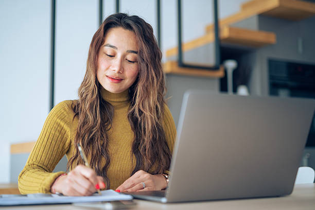 istock Balancing work & life: Asian woman working from home. 2208028361