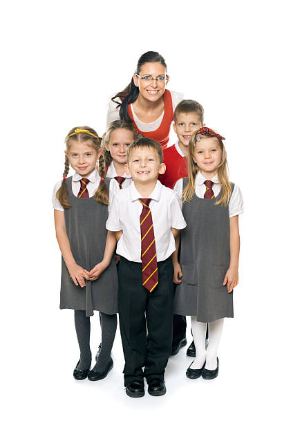 Teacher With Happy School Kids, Studio Portrait