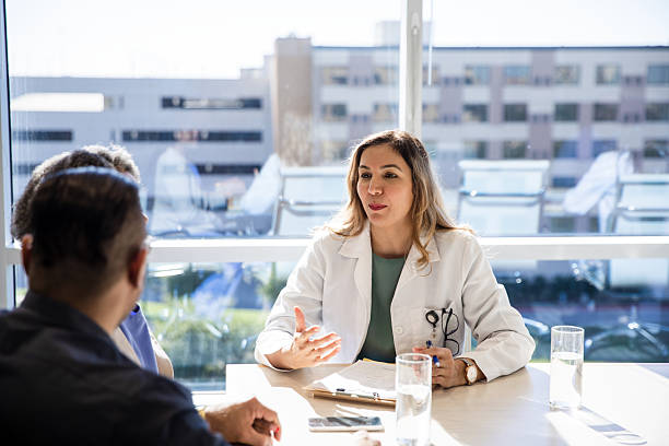istock Doctor Discussing Treatment Plan with Patients in Office 2208039880