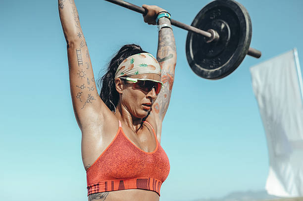 istock Strong Woman Lifting Weights Outdoors 2208040356