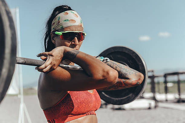 istock Strong Woman Lifting Weights Outdoors 2208040360