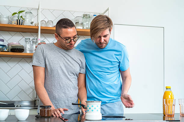 istock Joyful Gay Couple Cooking in Kitchen 2208040481