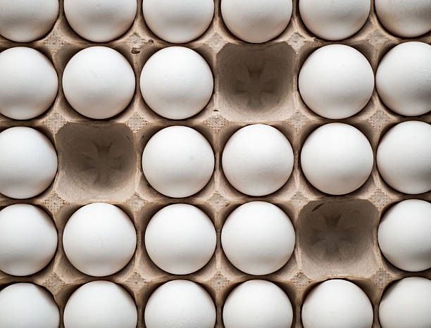 istock Top view of carton of 30 white eggs with three missing. 2208040864