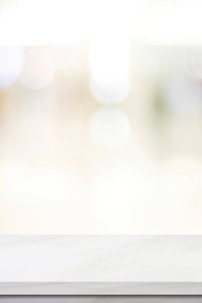 istock Empty vertical white table top, counter, desk background over blur  bokeh background, White marble stone table, shelf and blurred kitchen restaurant for food, product display mockup, template 2208041137