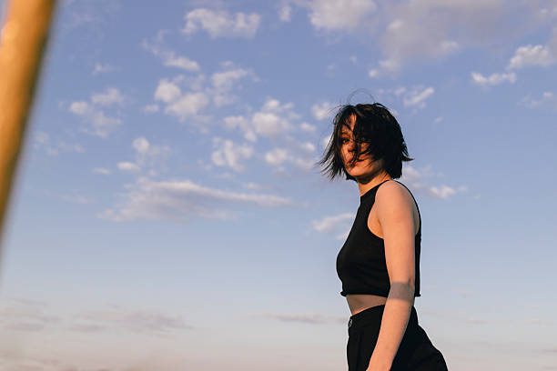 Bold Woman in Black Ensemble Against a Dreamy Sky in Belarus, Brest Region, Kobryn