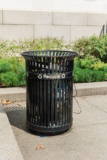 istock Outdoor black recycling bin filled with bottles and cans. 2208043048