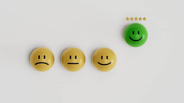 istock Customer service evaluation, ratings, feedback, client experience, and satisfaction survey concepts. Checkmark at five stars and hand pointing at happy face on yellow BALL block on white background. 2208043565