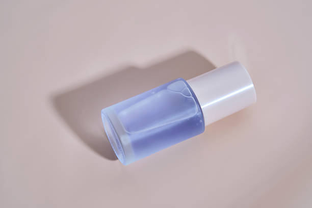 istock A bottle of blue serum on a delicate beige background. 2208050832