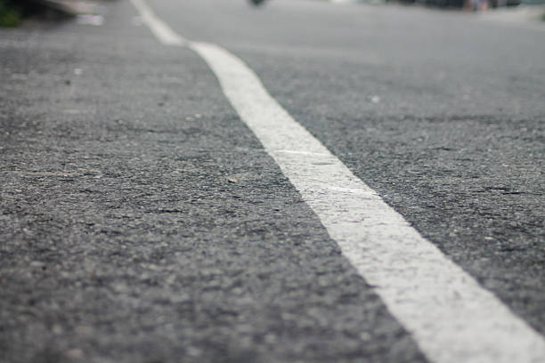 istock white marking lines on asphalt. Aerial View Of Empty Asphalt Road 2208050918