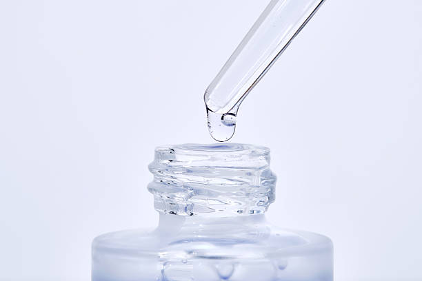 istock The blue serum drips from the dropper into the bottle. 2208050955