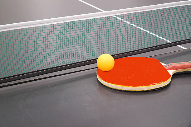 istock close up on ping pong racket and ball on the table 2208051279