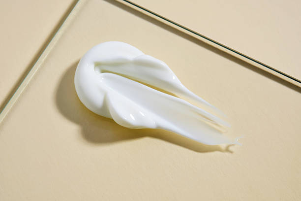 istock A smear of white cream on a beige background. 2208051421