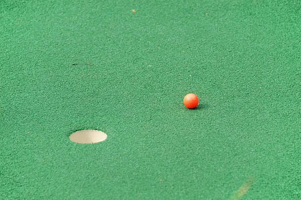 istock golf ball on plastic turf carpet near the hole 2208052142