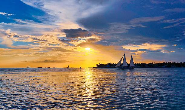 istock Sailboats at Sunset Over Ocean 2208053828