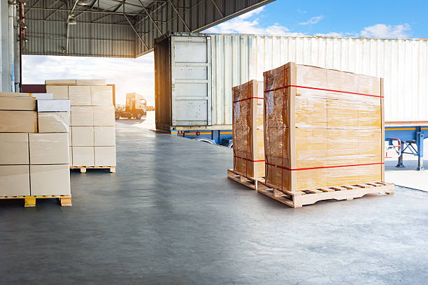 istock Bulk of Package Boxes Waiting to be Loaded into Containers Trucks. Distribution Shipping Cargo Container. Semi Trailer Trucks on The Parking Lot at Sunset. Freight Truck Logistics Transportation. 2208057920