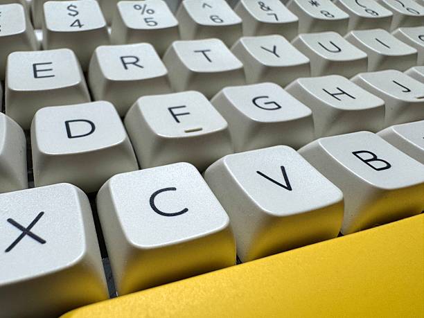 istock White keys on a mechanical keyboard with the letters C and V at close range for programmers, left side view 2208058762
