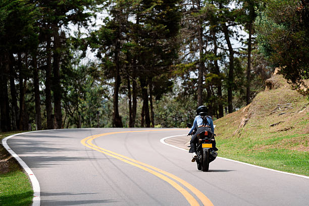 istock Couple riding motorcycle on scenic forest road during summer vacation 2208062036