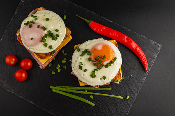 istock Delicious breakfast sandwich with eggs, ham, and fresh vegetables 2208062143
