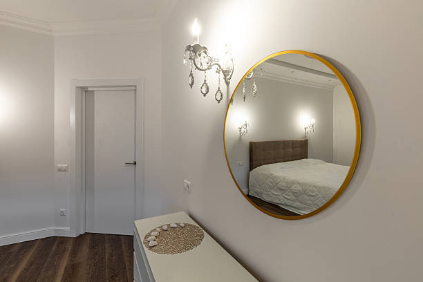 istock Elegant Bedroom Interior with Round Mirror Reflection 2208062632