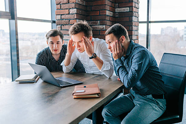 istock Young men in office express bewilderment over challenging laptop tasks and discoveries 2208063359