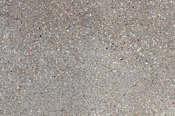 istock Rough texture of gray-brown wall. Wall from concrete with pebbles and cracks. Texture background for design 2208064354
