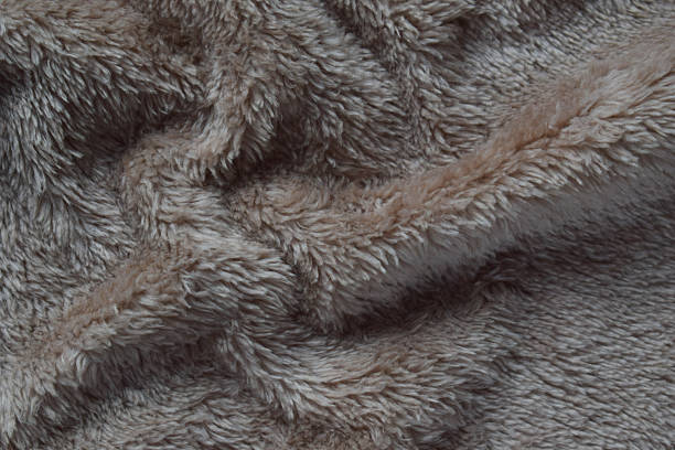 Luxurious plush fabric with a fluffy texture and warm beige color ideal for home decor inspiration textile industry and cozy lifestyle themes