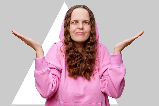 istock A person stands with a slightly puzzled expression, displaying open hands in a questioning gesture 2208064462
