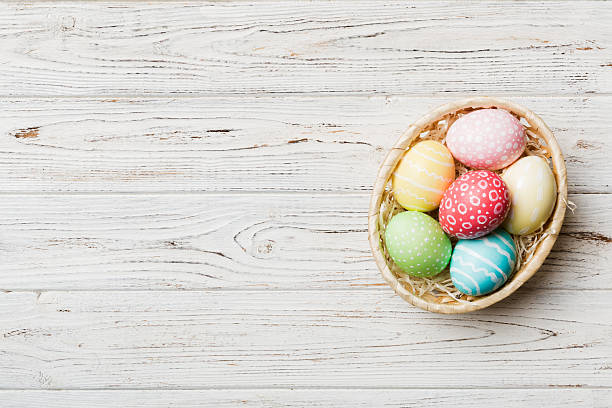 istock Multi colors Easter eggs in the woven basket on colored background . Pastel color Easter eggs. holiday concept with copy space 2208065838