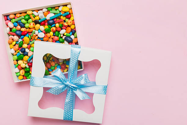 istock Box with sweet chocolate candies on color background, Various candy sweets. Valentines day gift box. Top view flat lay with copy space 2208065951