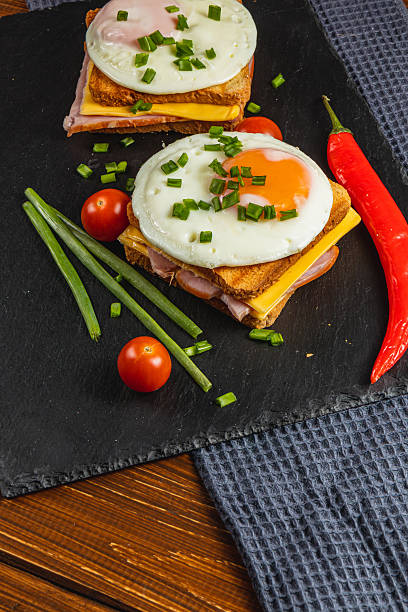 istock Delicious breakfast with toasted sandwiches, eggs, and fresh vegetables 2208066826