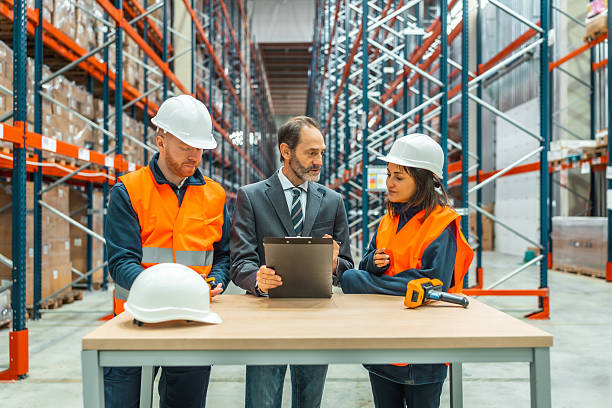 istock Warehouse workers and manager meeting and discussing logistics operations 2208068908