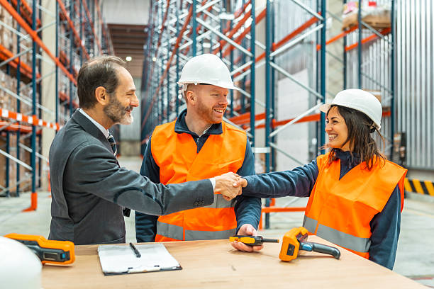 istock Manager shaking hands with warehouse workers in logistics center 2208069079