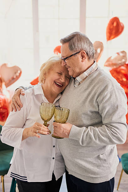 Romantic senior couple celebrating at home