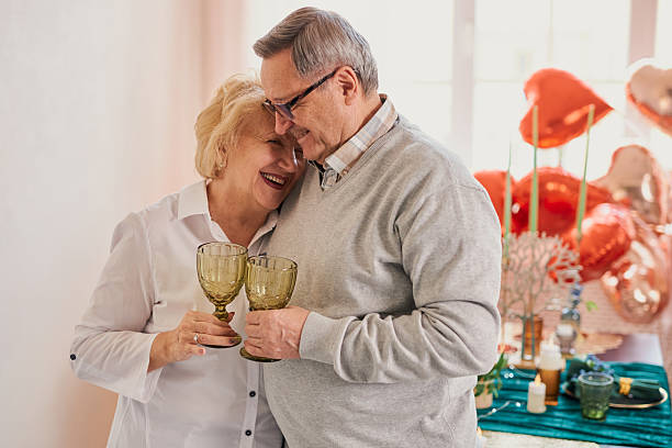 istock Romantic senior couple celebrating at home 2208069515
