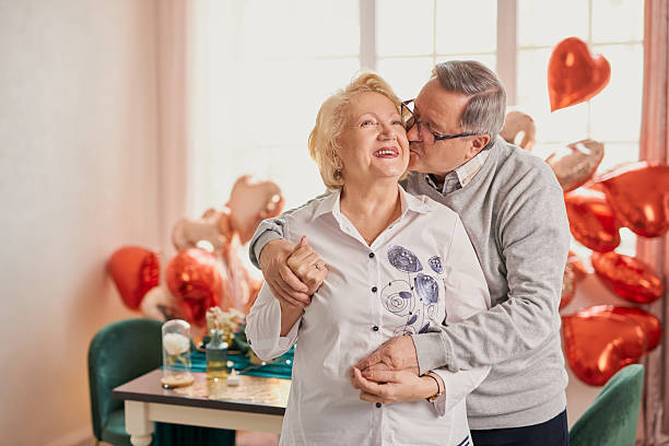 istock senior couple embracing during a celebration at home 2208069572