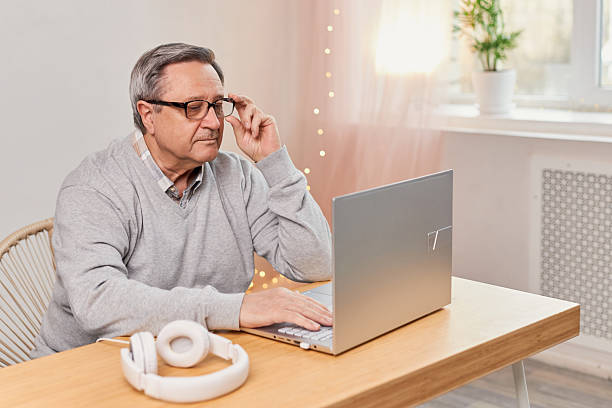 istock Senior man working intently on a laptop 2208070288