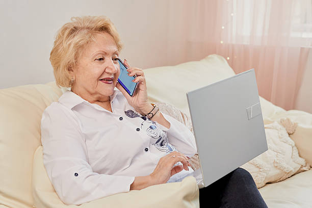 istock Senior woman comfortably using a laptop 2208070409