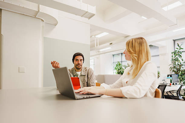 istock Confident man gesturing during a meeting with a female coworker 2208071182